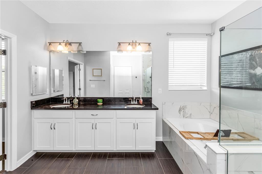 239 Lugano Way DeBary, FL 32713 - Photo 25 of 52 a bathroom with sinks granite countertop a sink and a bathtub