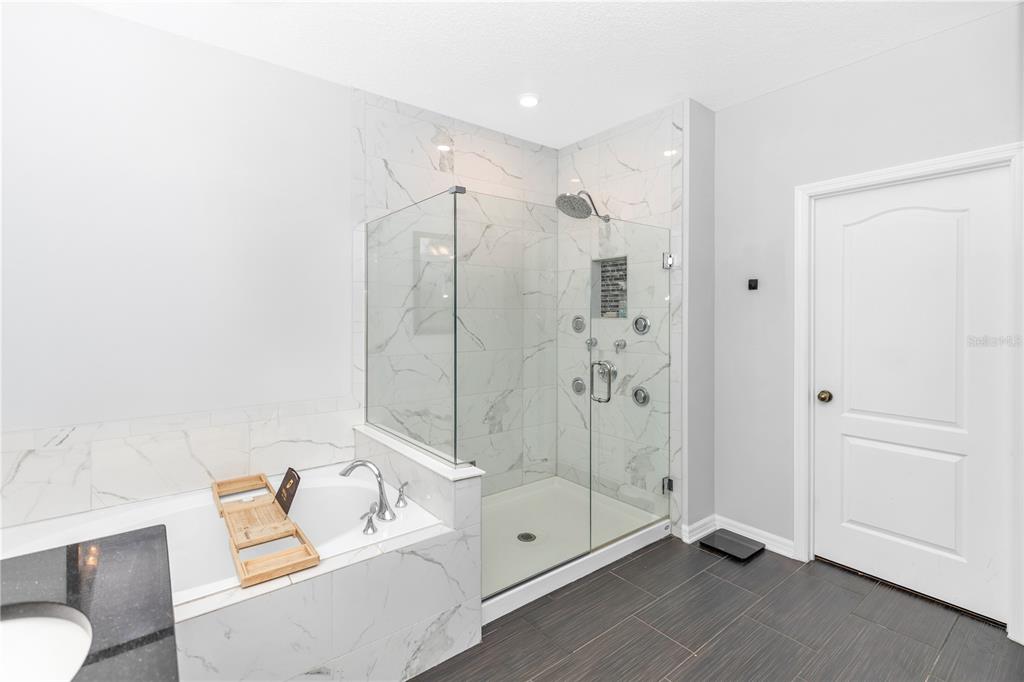 239 Lugano Way DeBary, FL 32713 - Photo 26 of 52 a bathroom with a tub shower and sink