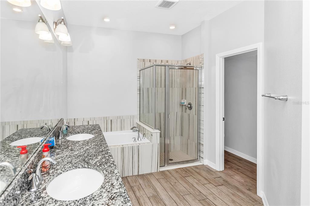 239 Lugano Way DeBary, FL 32713 - Photo 29 of 52 a bathroom with a sink vanity granite tub and shower