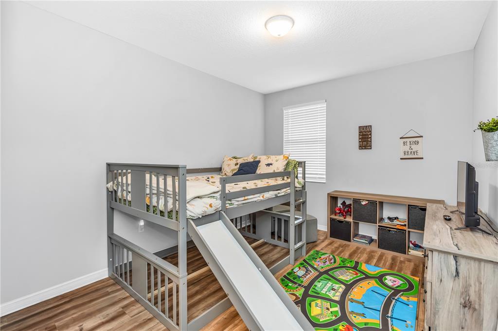 239 Lugano Way DeBary, FL 32713 - Photo 34 of 52 a bedroom with furniture and a book shelf
