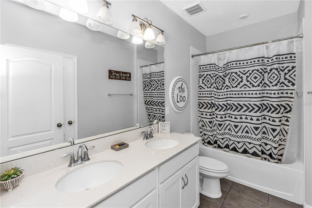 239 Lugano Way DeBary, FL 32713 - Photo 36 of 52 a bathroom with a sink a toilet and shower