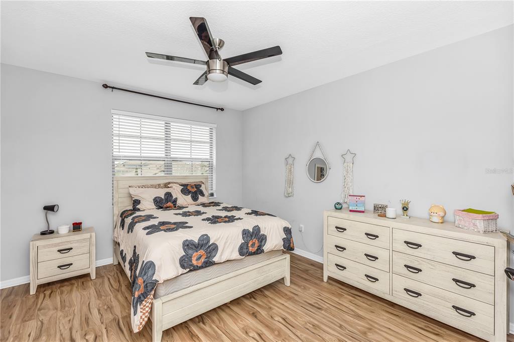 239 Lugano Way DeBary, FL 32713 - Photo 37 of 52 a bedroom with a bed and a dresser