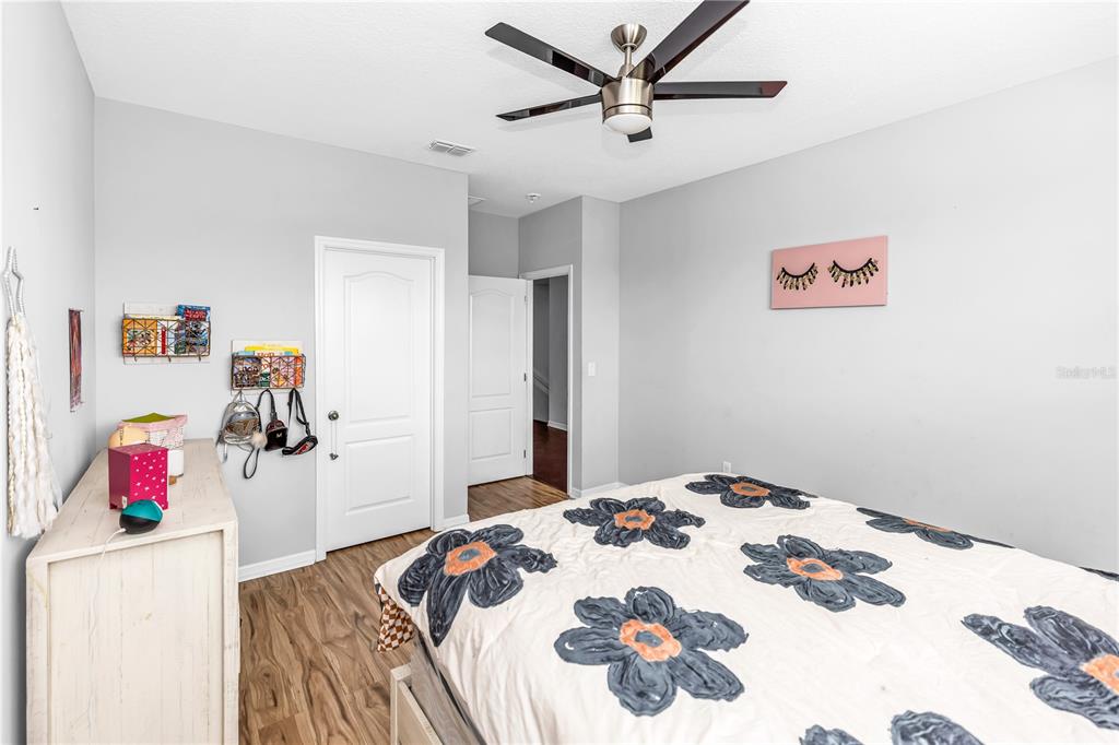 239 Lugano Way DeBary, FL 32713 - Photo 38 of 52 a bedroom with a bed and a chandelier