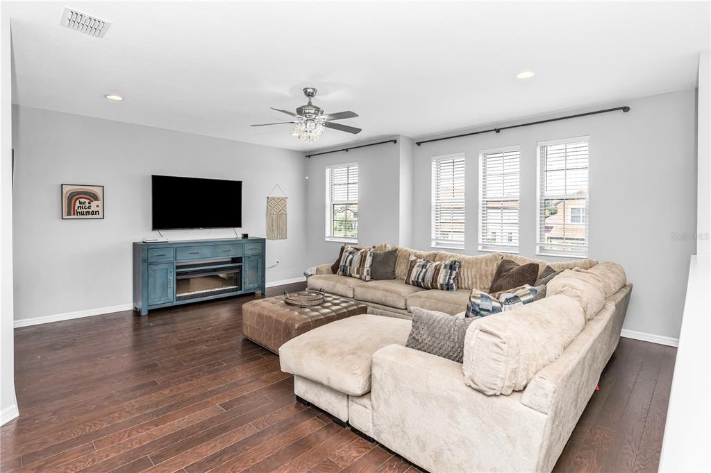 239 Lugano Way DeBary, FL 32713 - Photo 39 of 52 a living room with furniture a fireplace and a flat screen tv