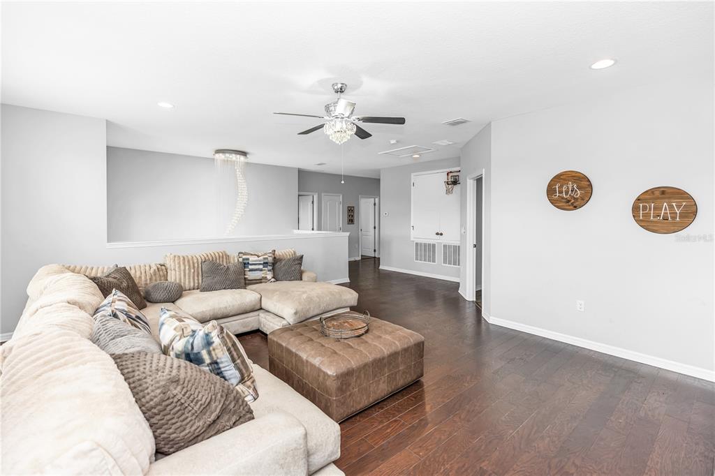 239 Lugano Way DeBary, FL 32713 - Photo 40 of 52 a living room with furniture and a wooden floor