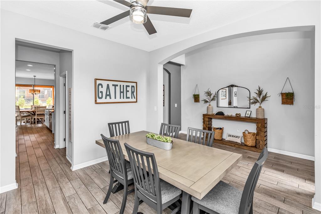 239 Lugano Way DeBary, FL 32713 - Photo 7 of 52 a view of a a dining room with furniture window and wooden floor