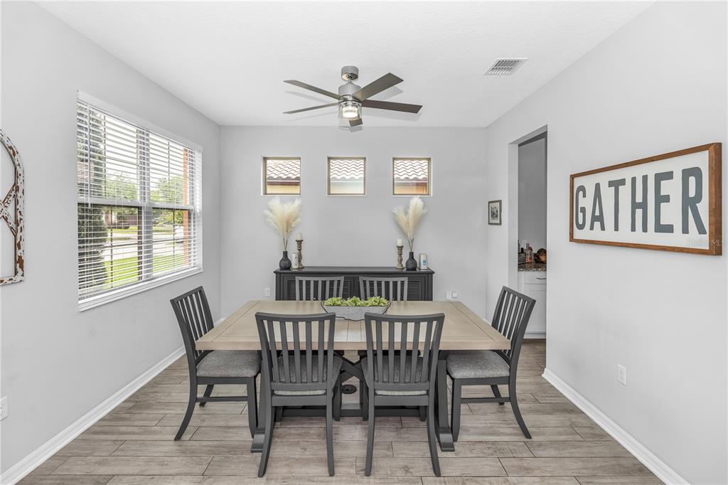 239 Lugano Way DeBary, FL 32713 - Photo 8 of 52 a view of a dining room with furniture window and wooden floor