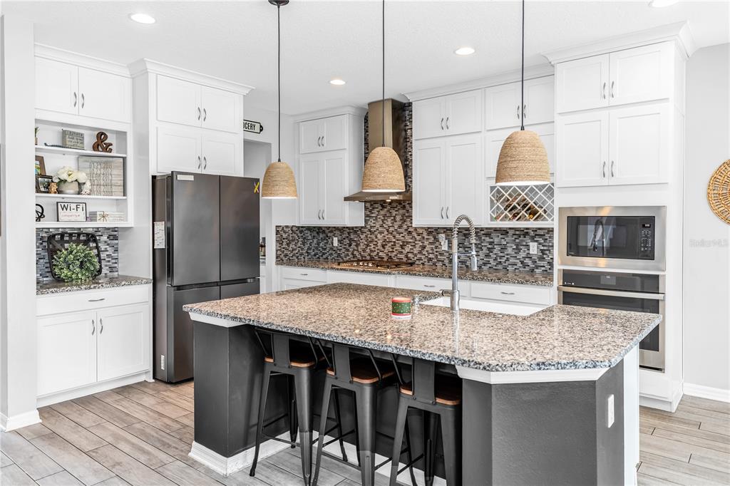 239 Lugano Way DeBary, FL 32713 - Photo 10 of 52 a kitchen with stainless steel appliances granite countertop a kitchen island a stove and a refrigerator