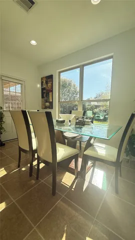 a living room with stainless steel appliances kitchen island granite countertop a sink and cabinets
