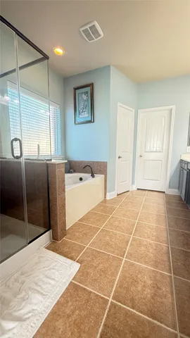a large bathroom with a sink mirror and window