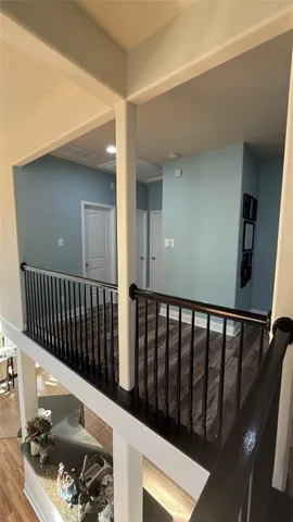 a view of a livingroom with wooden floor and a ceiling fan