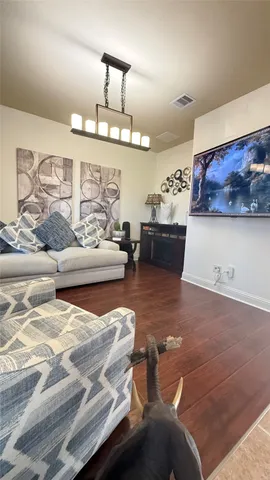 a living room with furniture and a chandelier