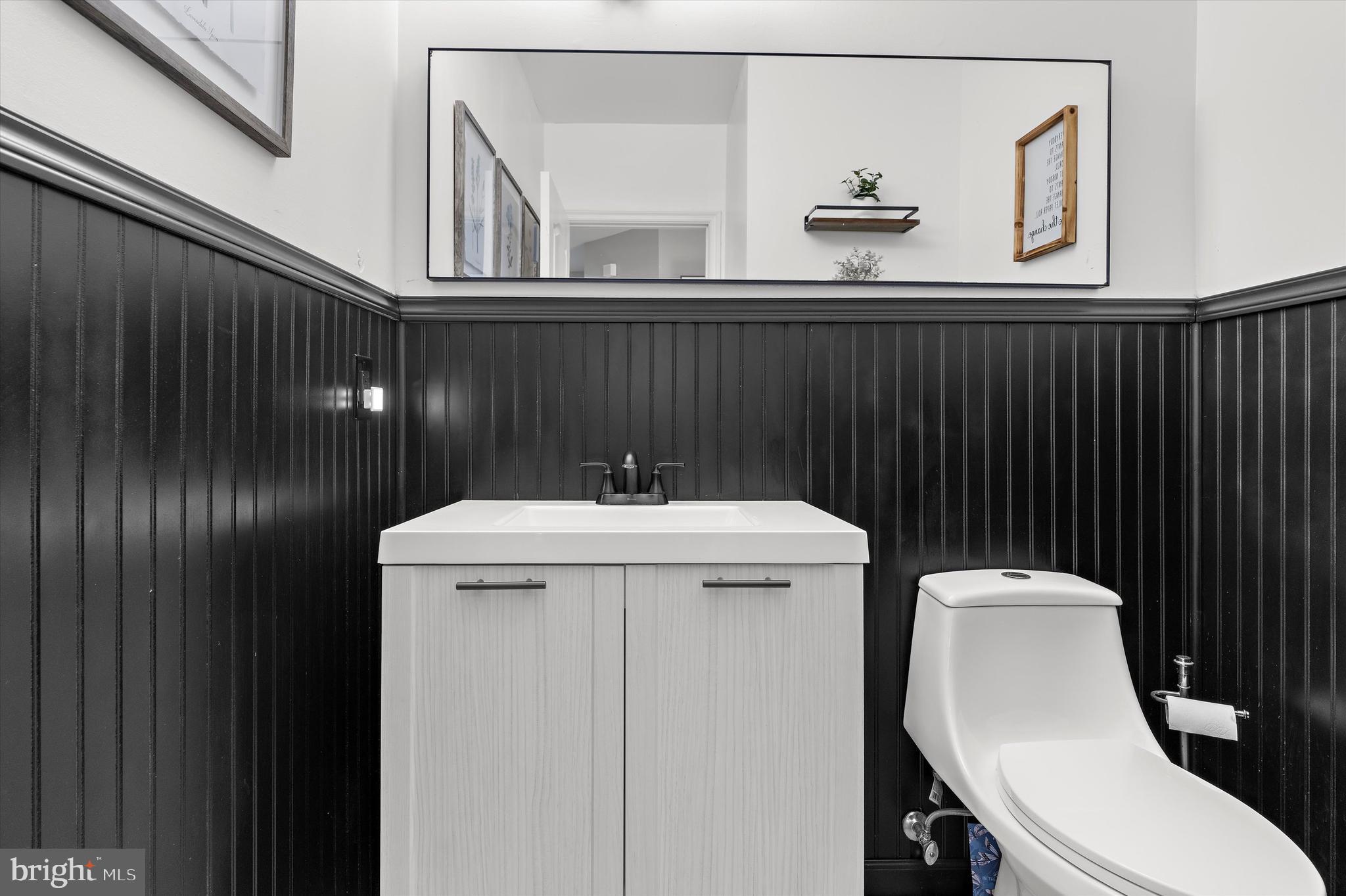 13159 Partridge Berry Court Waldorf, MD 20601 - Photo 20 of 63 a bathroom with a toilet a sink and mirror