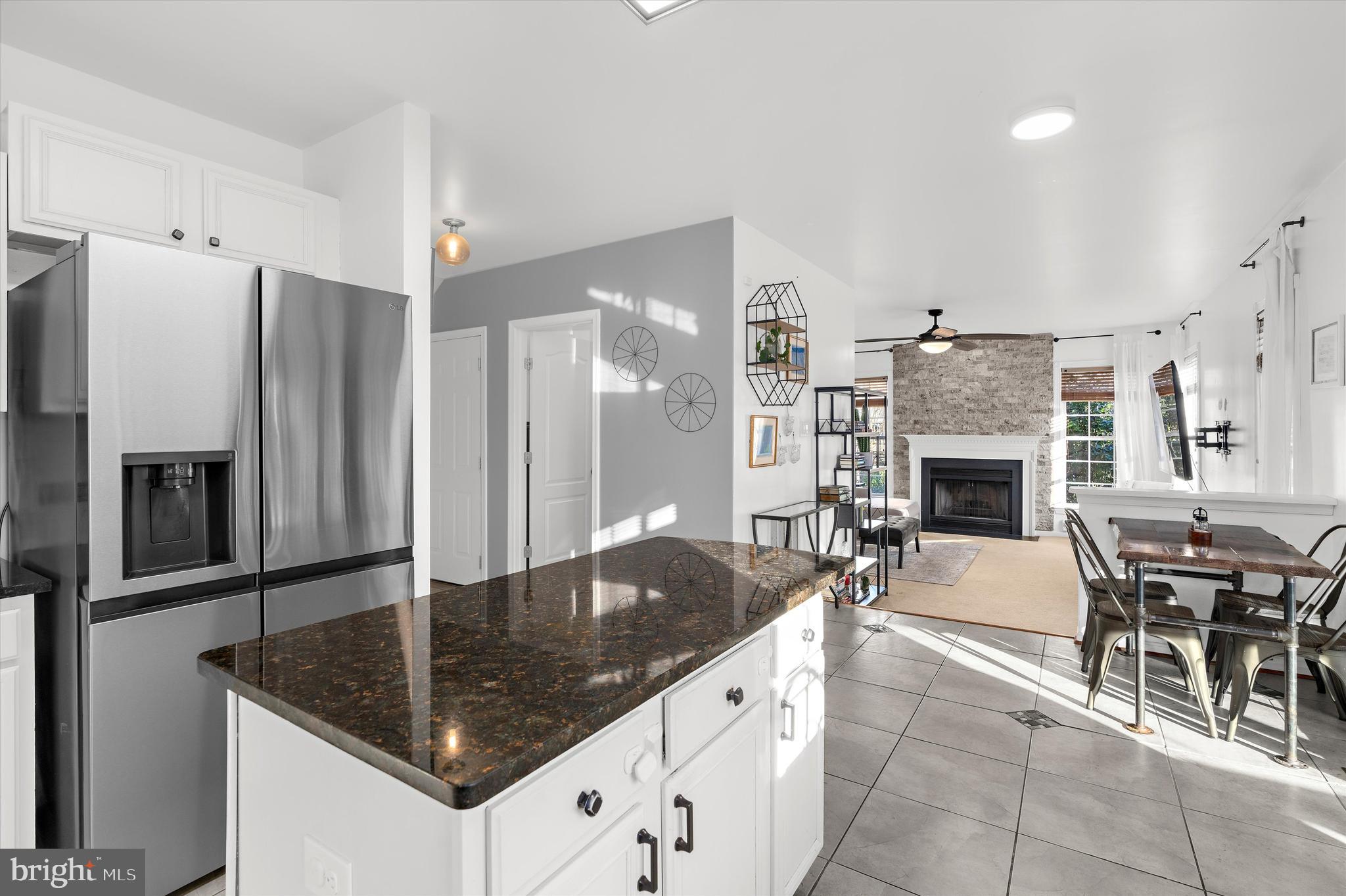 13159 Partridge Berry Court Waldorf, MD 20601 - Photo 6 of 63 a kitchen with stainless steel appliances granite countertop a table chairs and a refrigerator