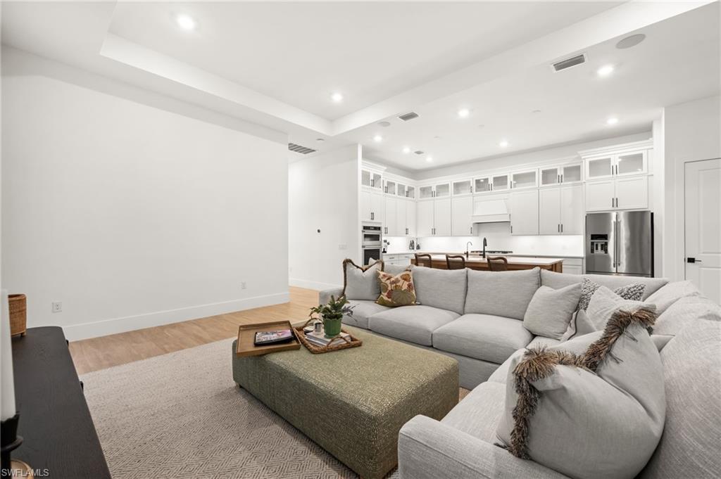 9565 Caymas Terrace Naples, FL 34114 - Photo 11 of 47 a living room with furniture and a view of kitchen