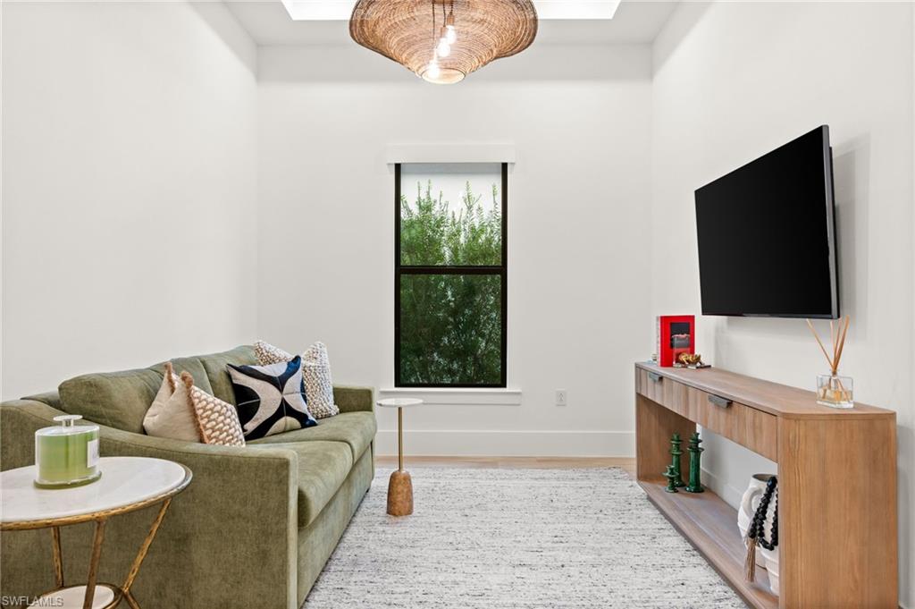9565 Caymas Terrace Naples, FL 34114 - Photo 22 of 47 a living room with furniture and a flat screen tv