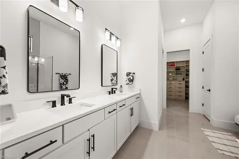 a spacious bathroom with a shower sink and mirror