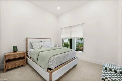 a bedroom with a bed and a night stand