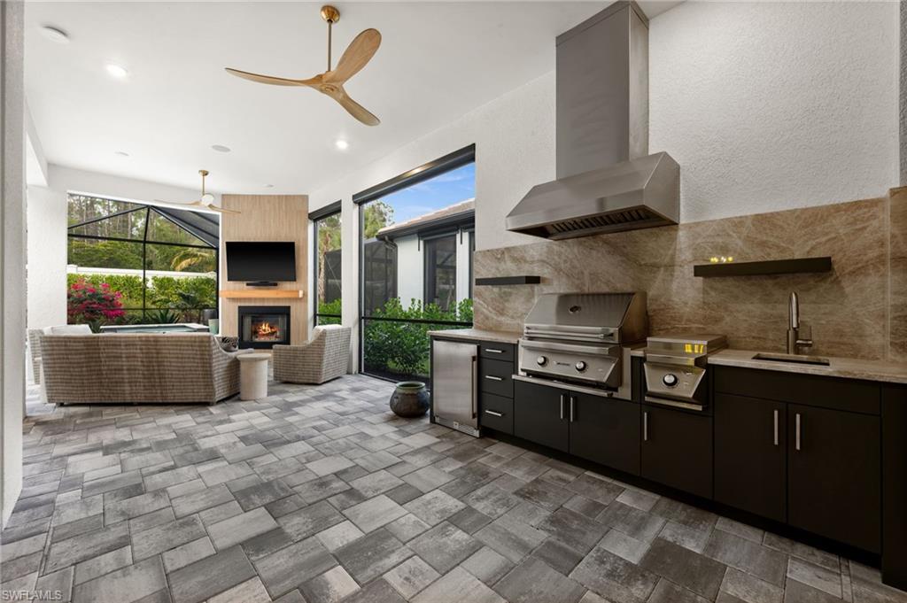 9565 Caymas Terrace Naples, FL 34114 - Photo 40 of 47 a kitchen with stainless steel appliances granite countertop a sink a stove and a refrigerator