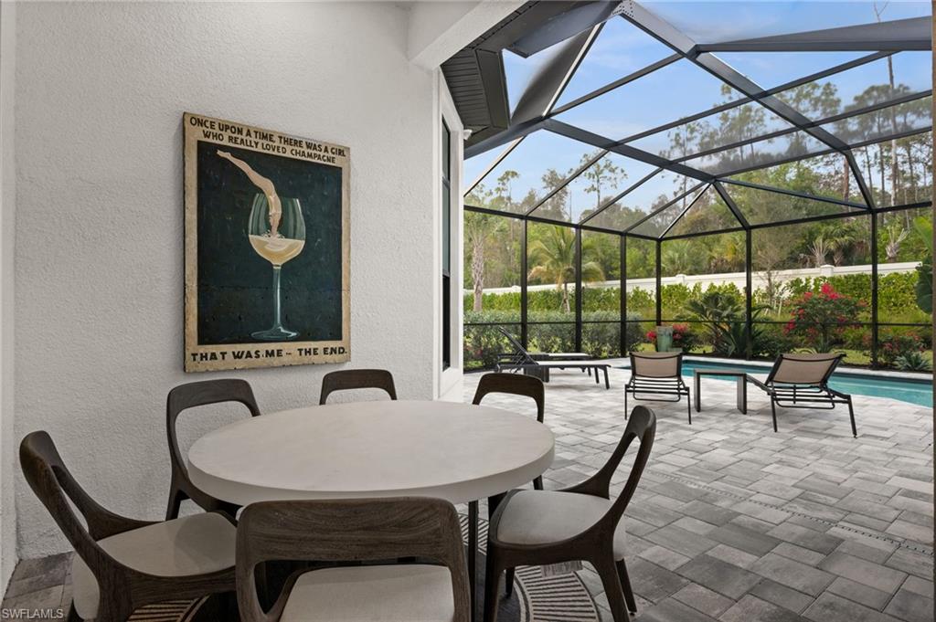 9565 Caymas Terrace Naples, FL 34114 - Photo 41 of 47 a outdoor dining space with furniture and outdoor view