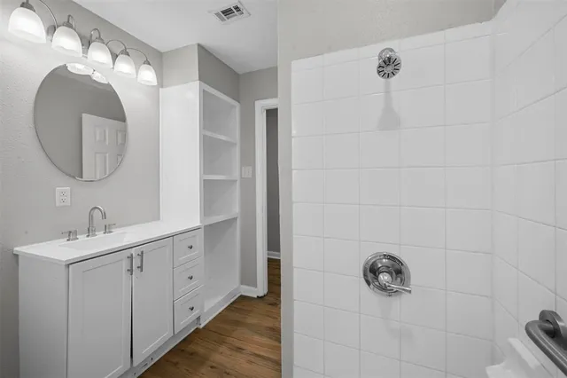 a bathroom with a double vanity sink and mirror