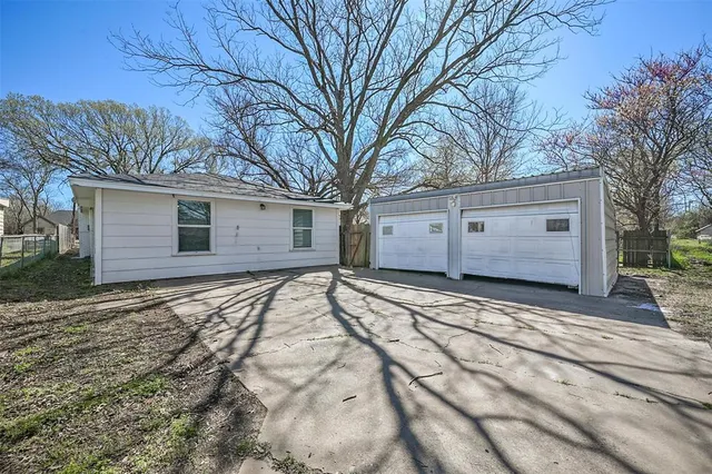 a view of garage yard and tree
