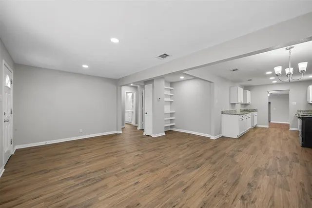 a view of a kitchen with wooden floor and a sink