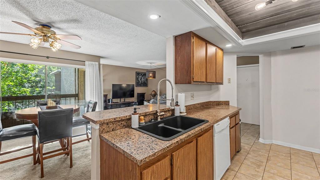 2025 Sylvester Road, Unit N305 Lakeland, FL 33803 - Photo 11 of 34 a kitchen with stainless steel appliances granite countertop a sink stove and cabinets