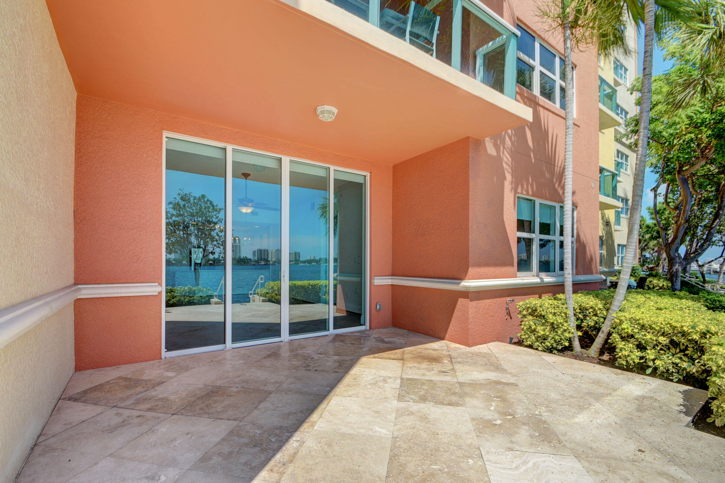 2640 Lake Shore Drive, Unit 115 Riviera Beach, FL 33404 - Photo 15 of 59 a view of a building with a garden