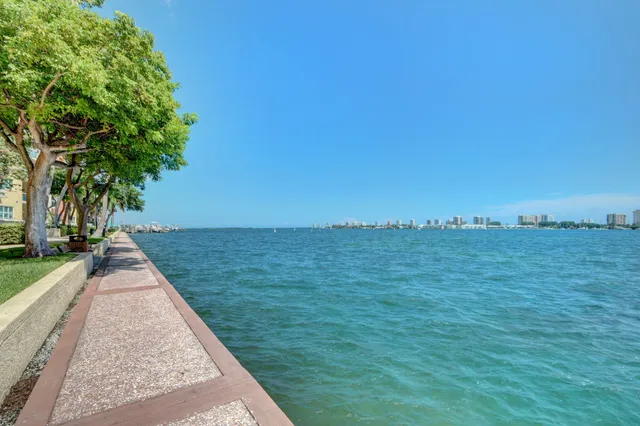 front view of front of a house with a yard and potted plants