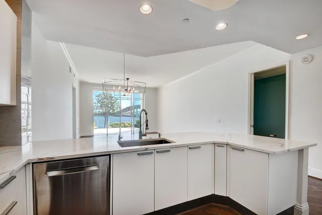 a bathroom with a tub a sink and mirror