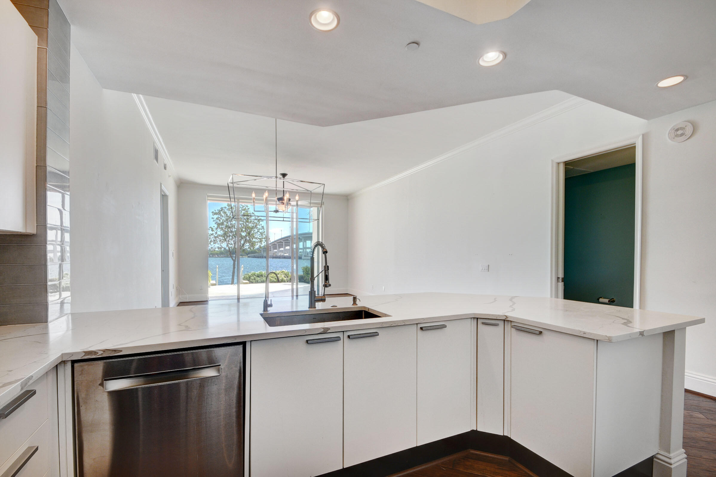 2640 Lake Shore Drive, Unit 115 Riviera Beach, FL 33404 - Photo 25 of 59 a kitchen with a sink and large window