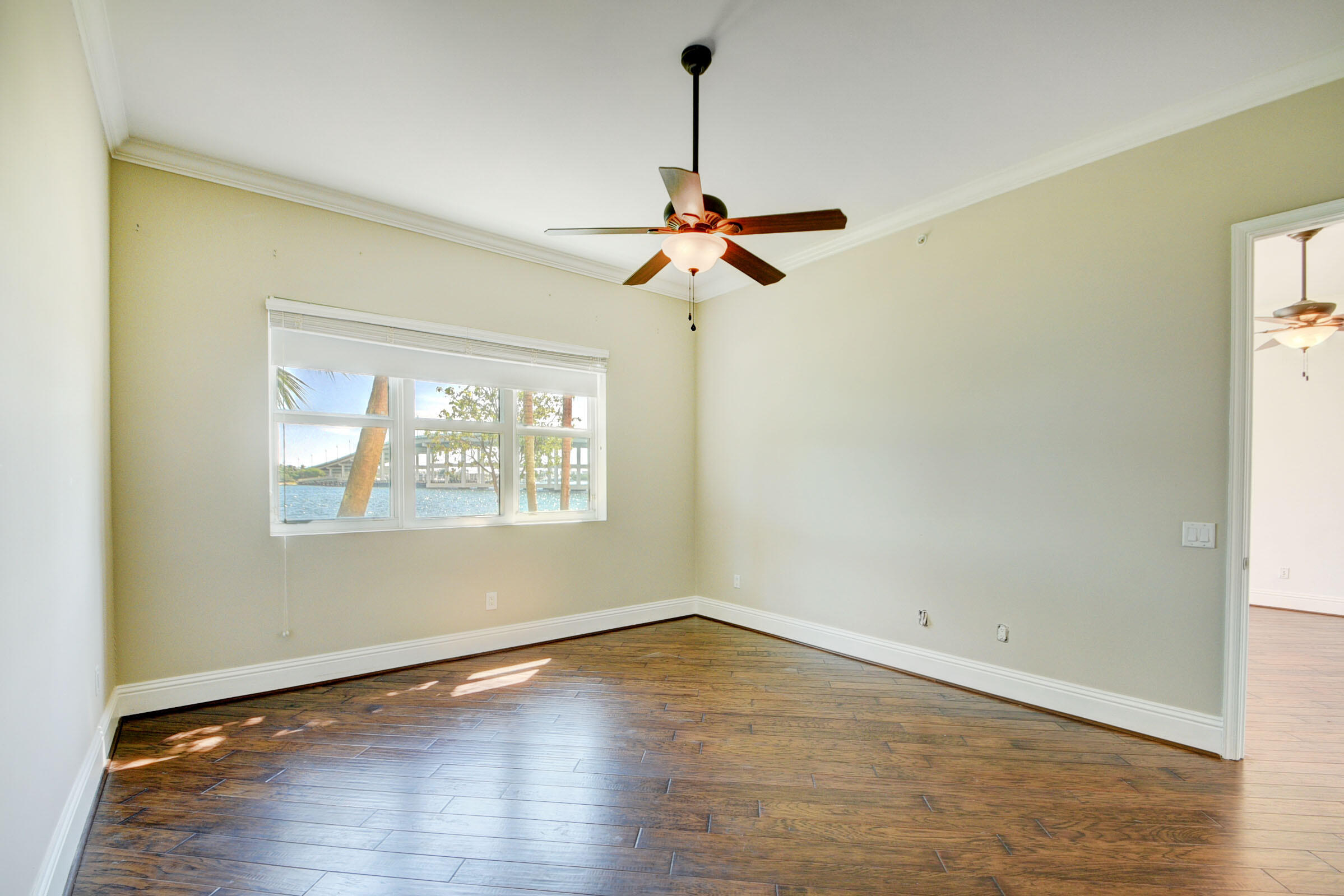 2640 Lake Shore Drive, Unit 115 Riviera Beach, FL 33404 - Photo 26 of 59 a view of a room with wooden floor chandelier and a window
