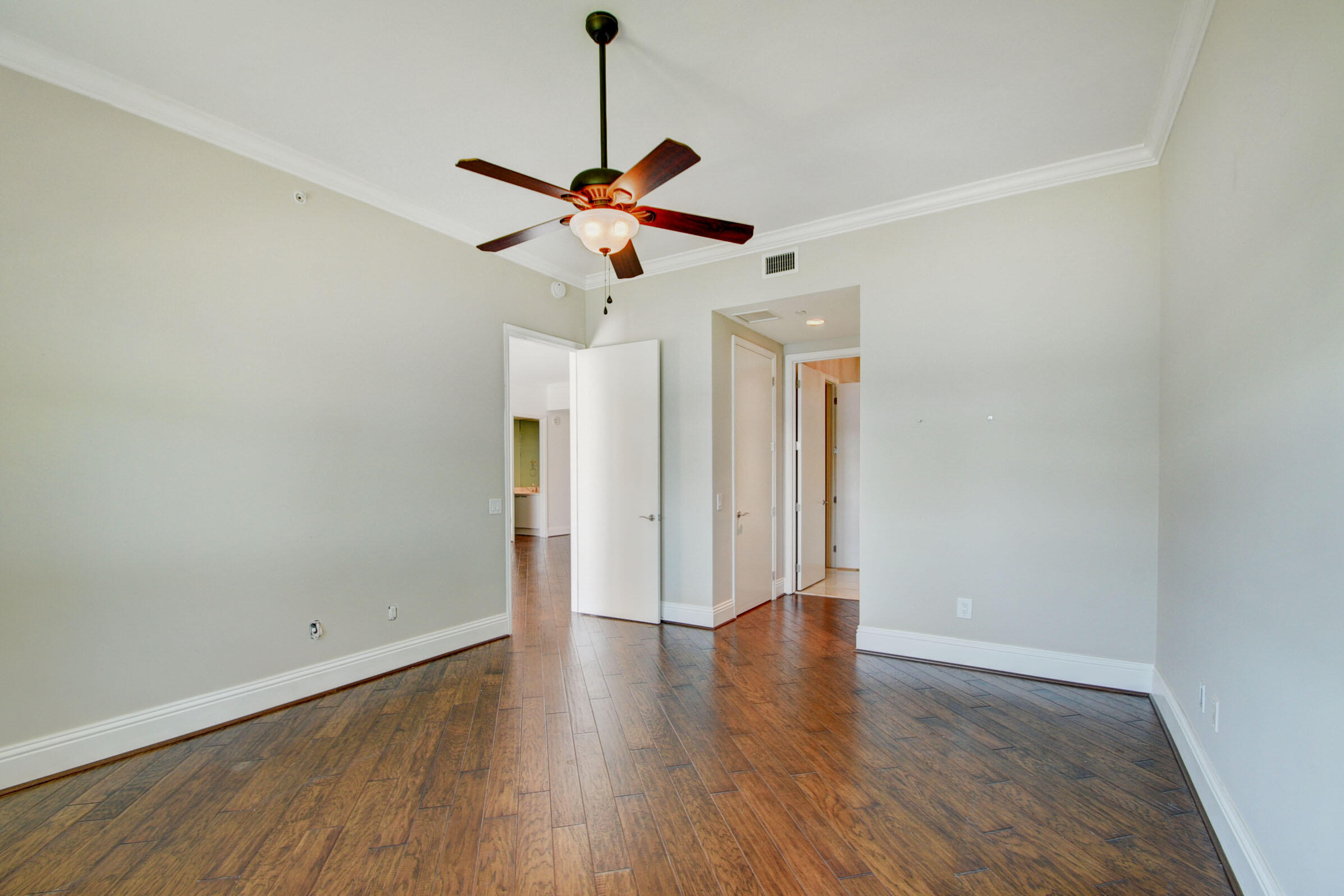 2640 Lake Shore Drive, Unit 115 Riviera Beach, FL 33404 - Photo 27 of 59 a view of a room with wooden floor and ceiling fan
