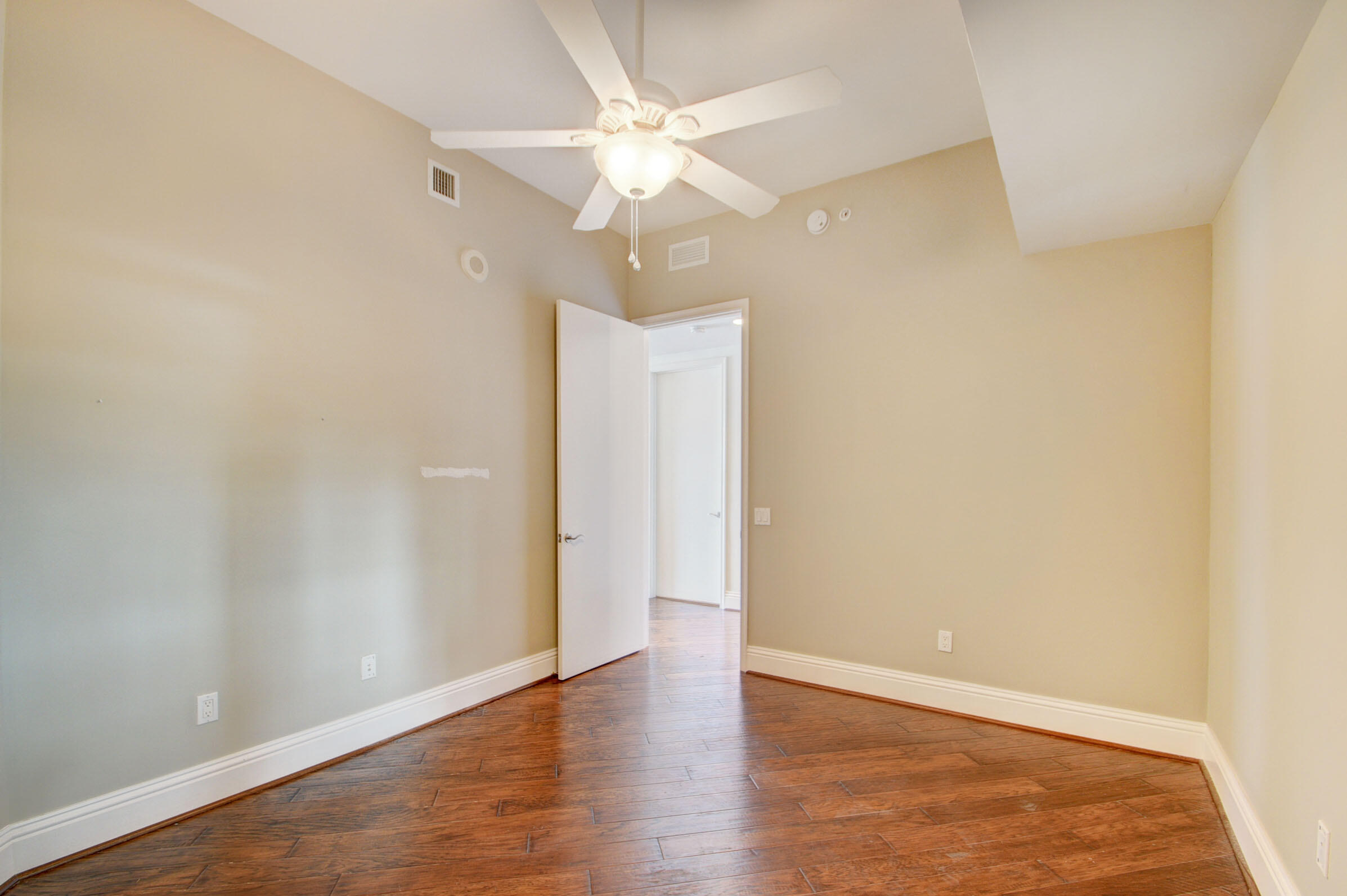 2640 Lake Shore Drive, Unit 115 Riviera Beach, FL 33404 - Photo 33 of 59 a view of an empty room with wooden floor