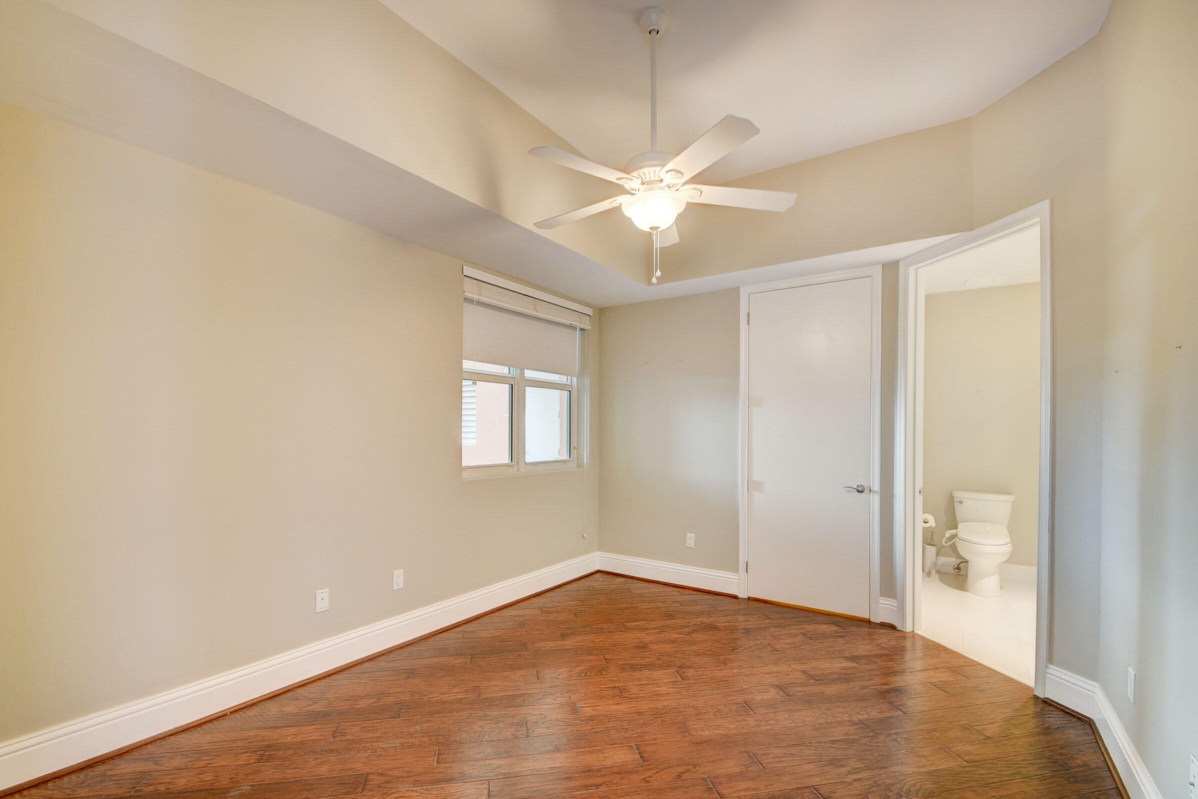 2640 Lake Shore Drive, Unit 115 Riviera Beach, FL 33404 - Photo 34 of 59 an empty room with a ceiling fan and a bathroom