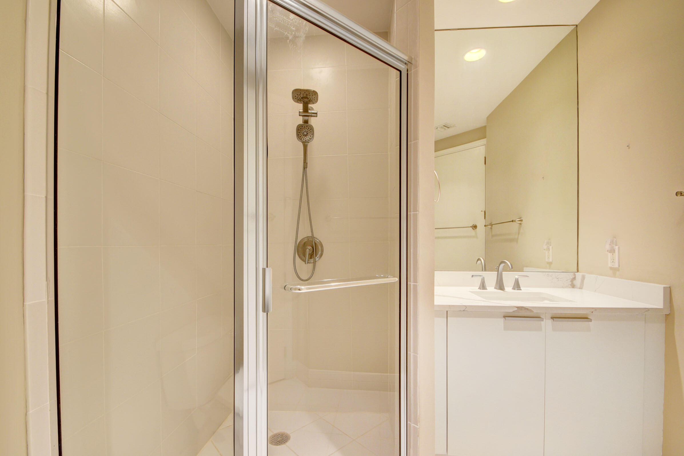 2640 Lake Shore Drive, Unit 115 Riviera Beach, FL 33404 - Photo 35 of 59 a bathroom with a granite countertop sink mirror and a