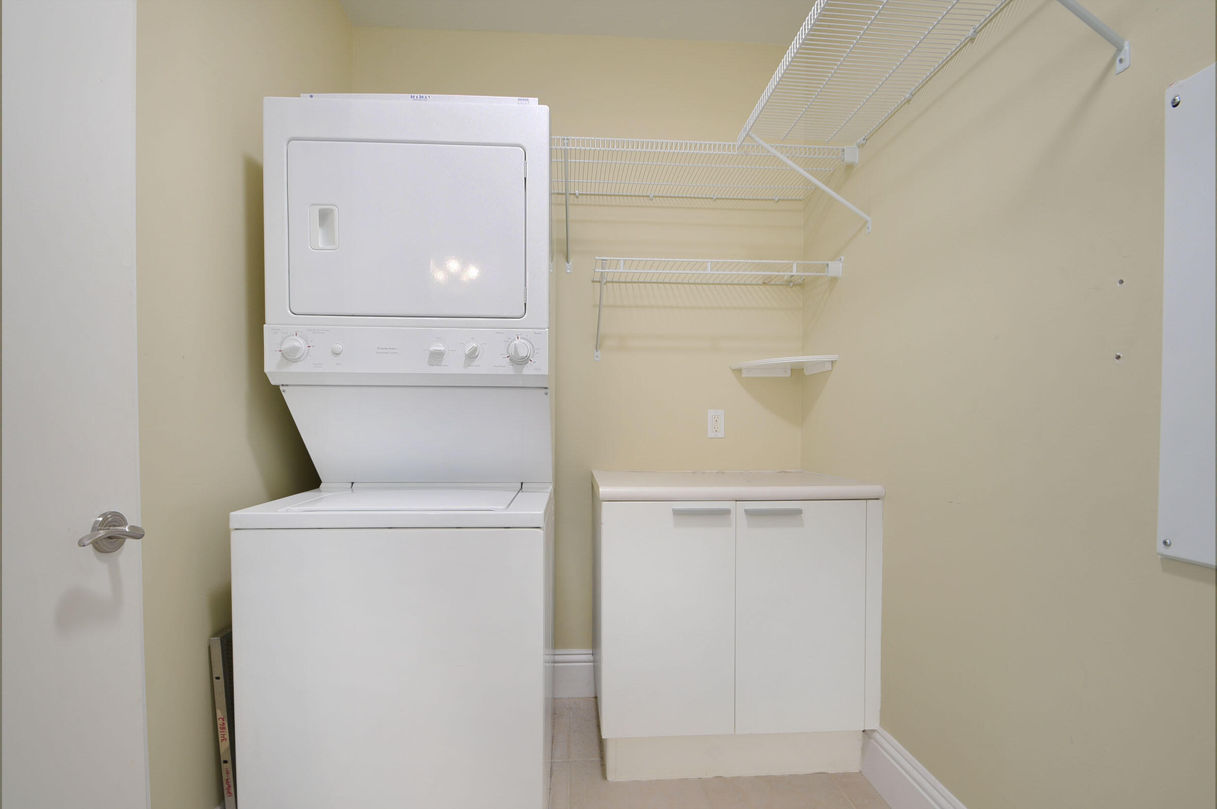 2640 Lake Shore Drive, Unit 115 Riviera Beach, FL 33404 - Photo 36 of 59 a utility room with dryer and washer