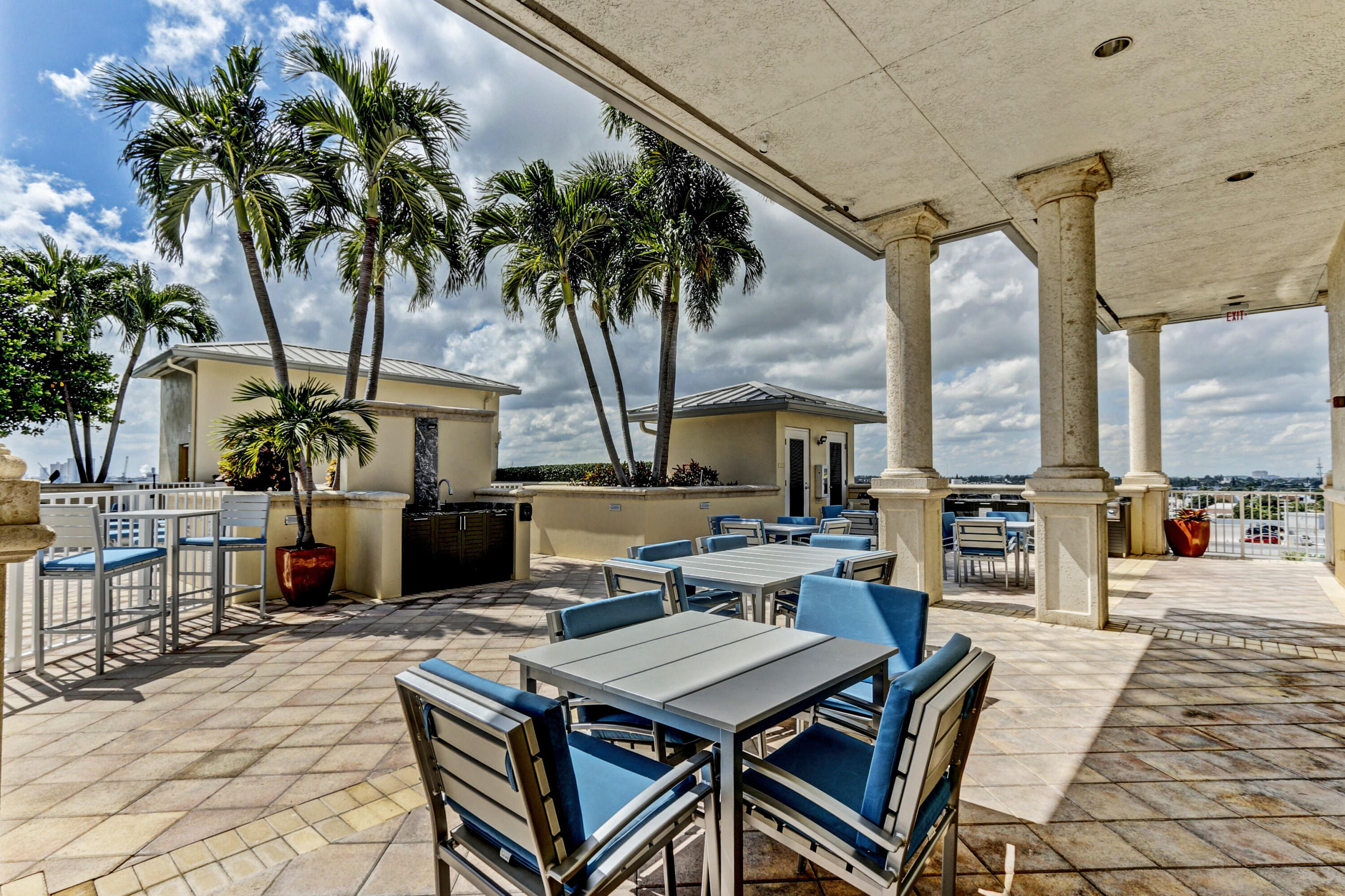2640 Lake Shore Drive, Unit 115 Riviera Beach, FL 33404 - Photo 52 of 59 a view of a dinning table and chairs in the patio