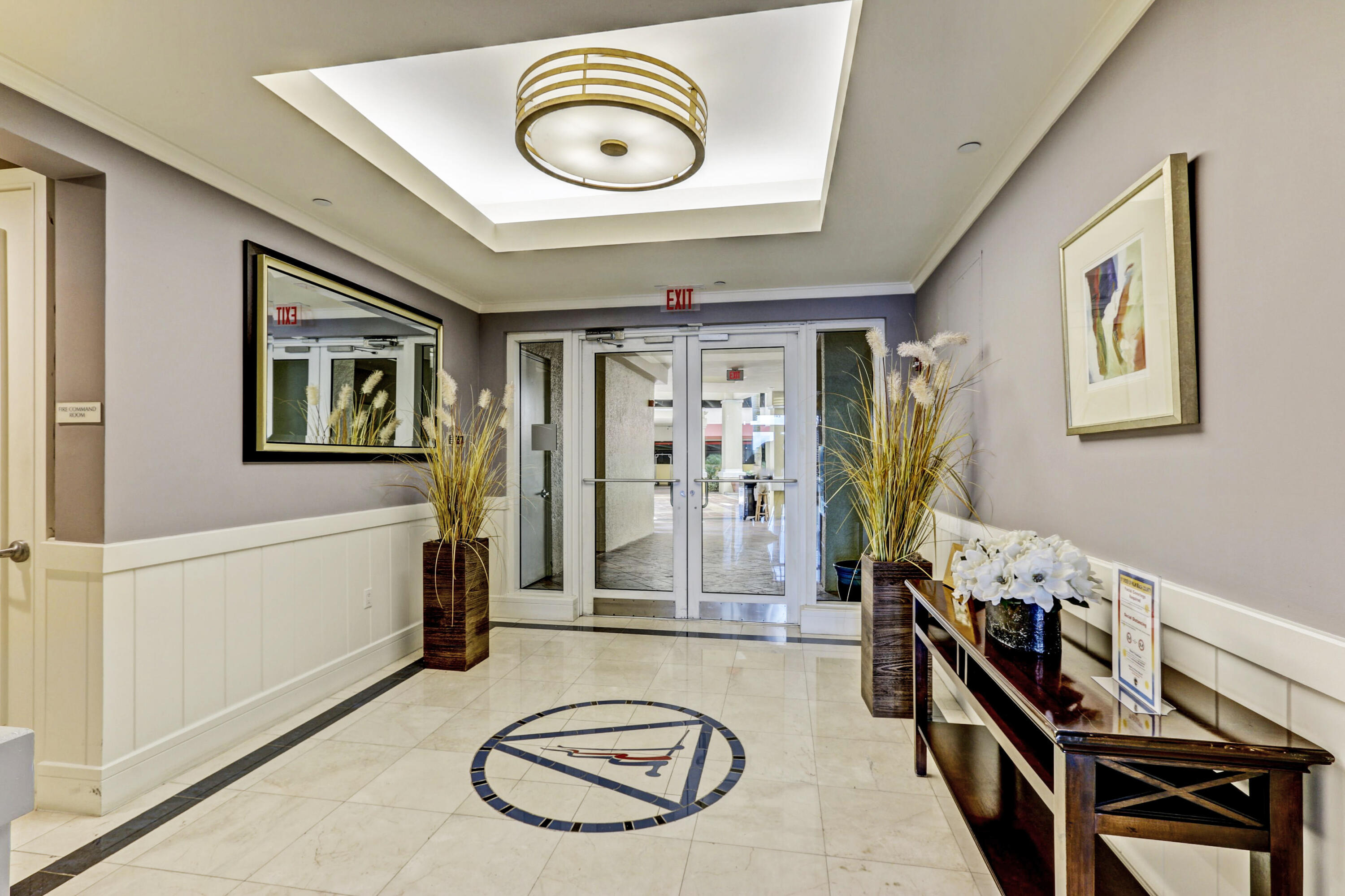 2640 Lake Shore Drive, Unit 115 Riviera Beach, FL 33404 - Photo 8 of 59 a view of a livingroom with furniture and entryway