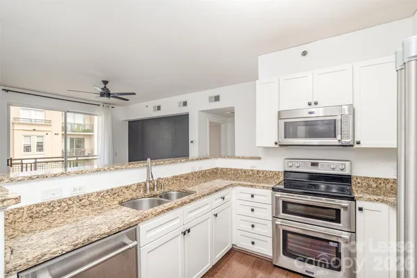 a bathroom with a granite countertop sink and mirror