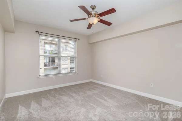 a view of an empty room and a ceiling fan