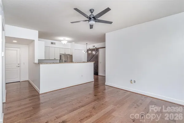 a kitchen with granite countertop a refrigerator and a sink