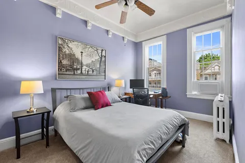 a bedroom with a bed and a chandelier