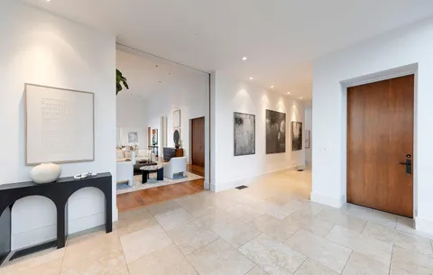 a kitchen that has a lot of cabinets in it and wooden floors