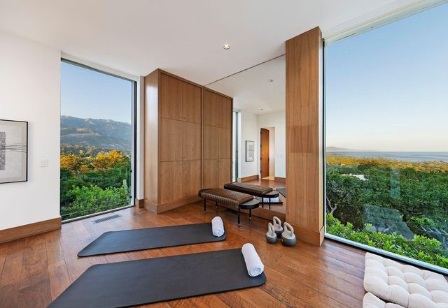 a bedroom with furniture and a large window