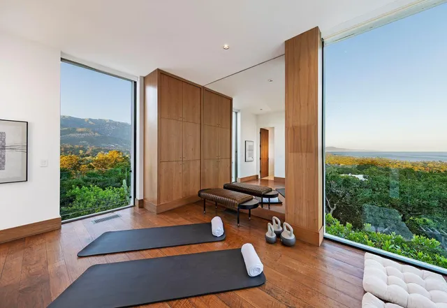 a bedroom with furniture and a large window