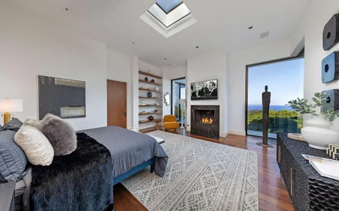 a bedroom with a bed and a fireplace