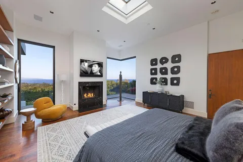 a bathroom with a tub a sink and large window