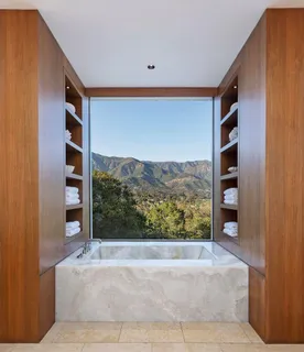 a bathroom with a bathtub shower sink and mirror
